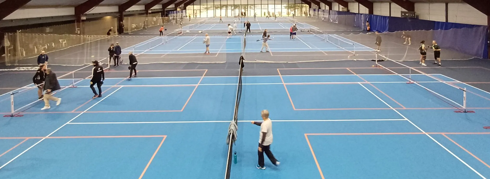 Tennis courts with pickleball lines marked out in tape — the usual